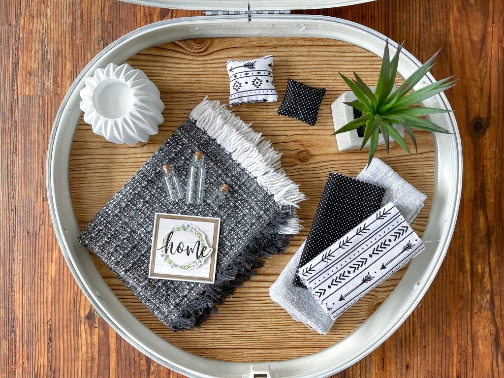 some of the materials needed to decorate a dollhouse made from a vintage suitcase