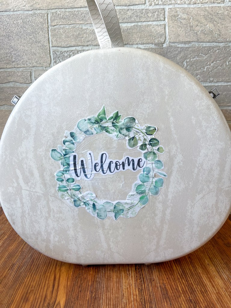 Welcome wreath decopauged on the front of the vintage suitcase dollhouse