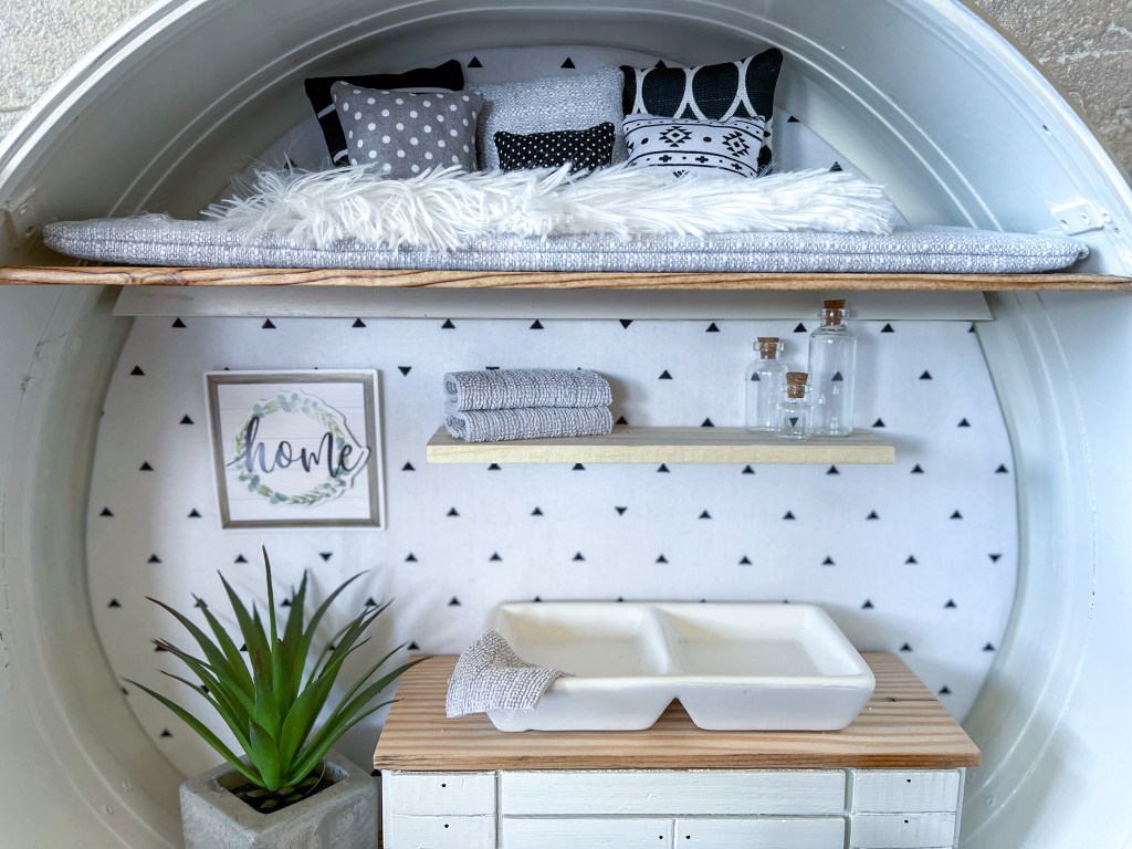 Tiny kitchen and loft in a dollhouse made in a vintage suitcase