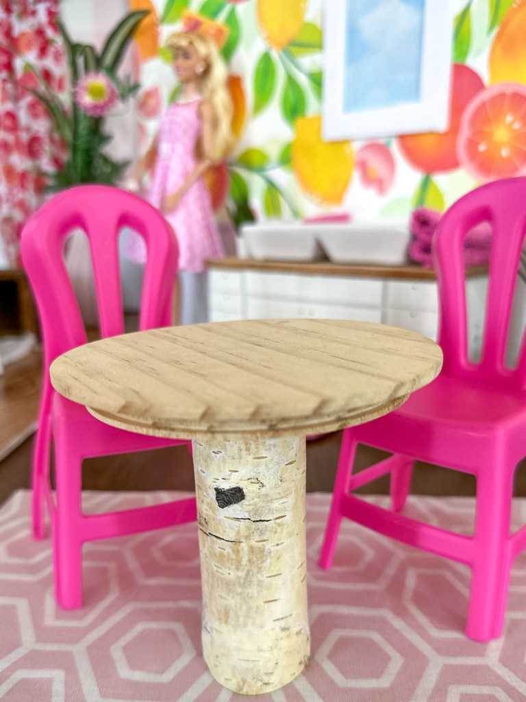 Close up of the kitchen table in a modern cardboard fold-out Barbie house based on the 1962 version